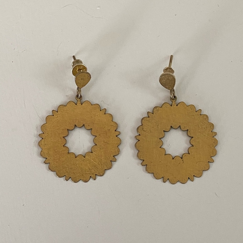 Matte gold laser cut hoop earrings on a post